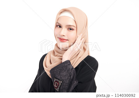 Beautiful young asian muslim woman wearing a beige hijab on white background, Portrait of Arab Beauty. Beautiful young asian muslim woman wearing a beige hijab on white background, Portrait of Arab Beauty. 114030092