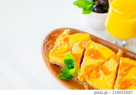 Baked vanilla and tropical flavour cheesecake swirled with passion fruit sauce on a digestive biscuit crumb 114031097