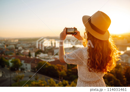Travel in Europe. Young woman enjoys sunrise. The concept of travel, tourism, vacation and freedom. Travel in Europe. Young woman enjoys sunrise. The concept of travel, tourism, vacation and freedom. 114031461