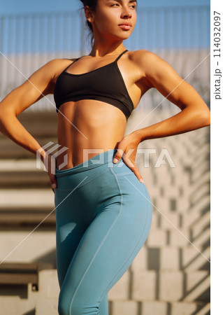 Fit Young woman in sportswear doing yoga, fitness exercise on the street. Sport, Active life. Fit Young woman in sportswear doing yoga, fitness exercise on the street. Sport, Active life. 114032097