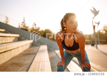 Fit Young woman in sportswear doing yoga, fitness exercise on the street. Sport, Active life. 114032110
