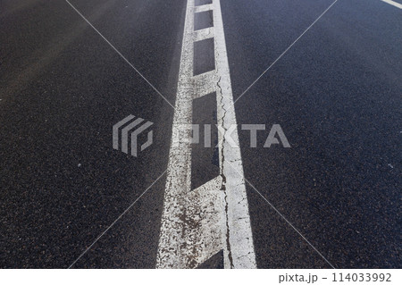 old road markings on the highway in winter 114033992
