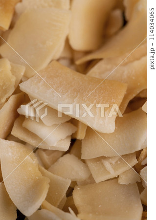 sweet orange and yellow coconut flakes fried in sugar sweet orange and yellow coconut flakes fried in sugar 114034065