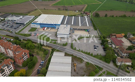 Aerial view Industrial zone. Top view of the city San Giuliano Milanese. Drone view of houses and streets on a spring day. Milan, Lombardy, Italy Aerial view Industrial zone. Top view of the city San Giuliano Milanese. Drone view of houses and streets on a spring day. Milan, Lombardy, Italy 114034502