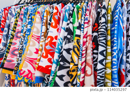 Asian dresses made of silk fabric with bright colorful pattern at oriental bazaar in India close-up 114035297