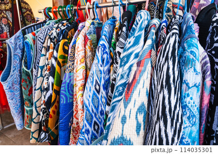 traditional Asian Uzbek dresses with colorful pattern at oriental bazaar of Uzbekistan 114035301