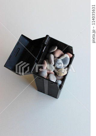 Opened Lid Of Black Box With Colored Sea Stones On White Surface Vertical Stock Photo 114035631