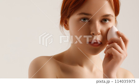 Nude makeup. Beautiful young girl applying face 114035975