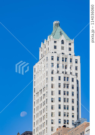 Sunny view of a historical building with a moon 114036060