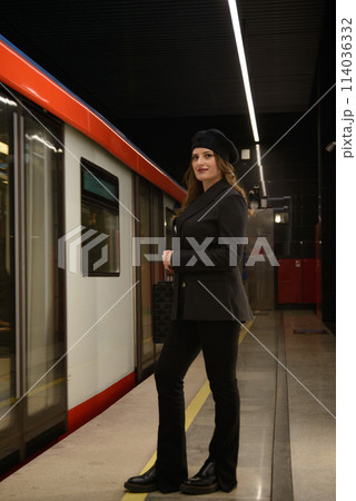 Beautiful lonely girl in black posing in the subway. Beautiful lonely girl in black posing in the subway. 114036332