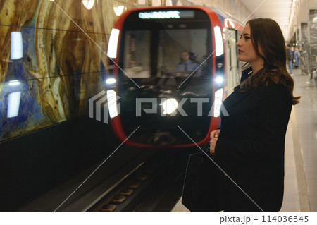 Beautiful lonely girl in black posing in the subway. Beautiful lonely girl in black posing in the subway. 114036345