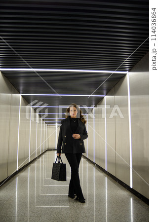 Beautiful lonely girl in black posing in the subway. 114036864