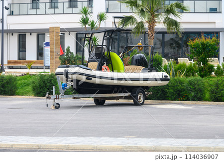 Recreational boat on trailer stored on driveway of residential home.1 Recreational boat on trailer stored on driveway of residential home.1 114036907