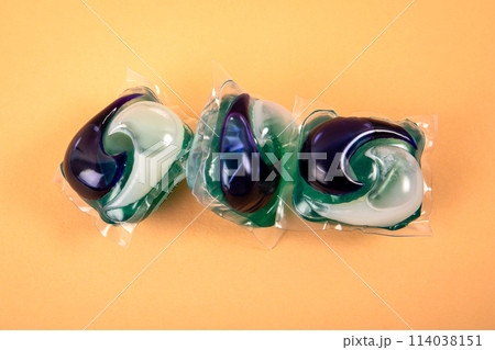 Laundry capsules in a pile on a light background 114038151