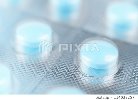 Blue tablets in blister. Macro shot. Stock photo. Blue tablets in blister. Macro shot. Stock photo. 114038257