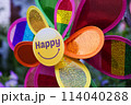 A colorful pinwheel with happy on the front 114040288