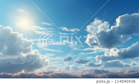 Serene sky panorama with gentle clouds bathed in soft sunlight creating a tranquil atmosphere 114040436