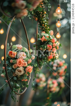 A series of flower arrangements are suspended from the ceiling, creating a warm 114044516