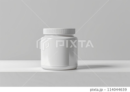 A jar with a gold lid sits on a white surface A jar with a gold lid sits on a white surface 114044639
