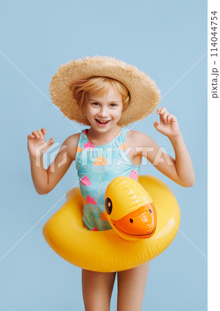 A young girl wearing a yellow bathing suit 114044754