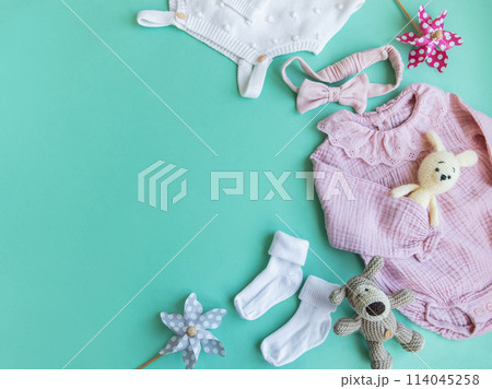 Set of pink clothes and accessories for newborn baby. Knitted toys rabbit and dog, romper, socks and handband Set of pink clothes and accessories for newborn baby. Knitted toys rabbit and dog, romper, socks and handband 114045258