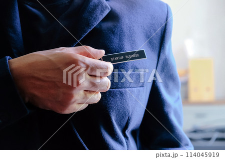 businessman holding a startup business label in his hand 114045919
