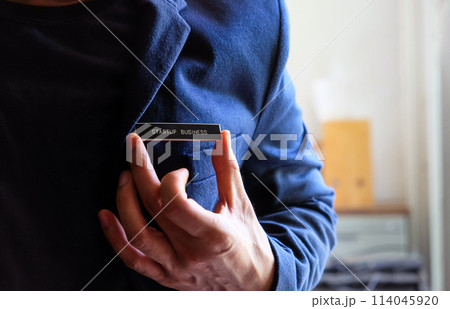 businessman holding a startup business label in his hand 114045920