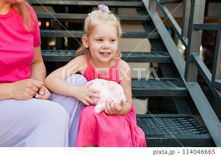 Funny baby with cochlear implant walks outdoor. Hearing aid and medicine innovating technology concept. Diversity and Inclusion and people with disability concept. Funny baby with cochlear implant walks outdoor. Hearing aid and medicine innovating technology concept. Diversity and Inclusion and people with disability concept. 114046665
