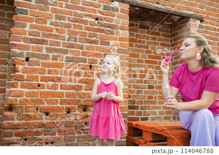 Child girl with cochlear implant with her mother spend time outdoor. Hear impairment and deaf community concept. Deaf and health concept. Disability and inclusion. Copy space Child girl with cochlear implant with her mother spend time outdoor. Hear impairment and deaf community concept. Deaf and health concept. Disability and inclusion. Copy space 114046788