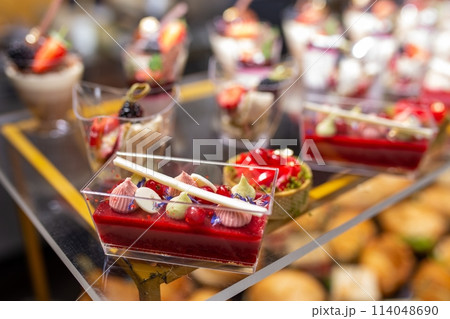 Delectable and colorful mini desserts arranged on a catering table 114048690