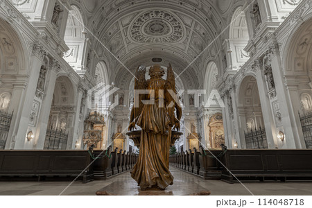 Behind an Archangel statue standing inside of St. Michael's Church. 114048718
