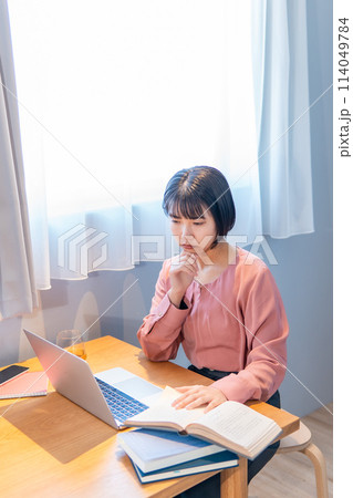 自宅で勉強/リモートワークをする女性 自宅で勉強/リモートワークをする女性 114049784