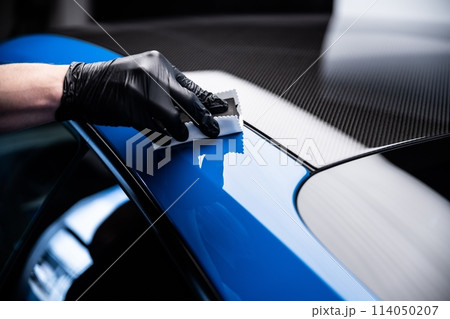 Car cash or car detailing studio worker applying graphene or ceramic coating Car cash or car detailing studio worker applying graphene or ceramic coating 114050207