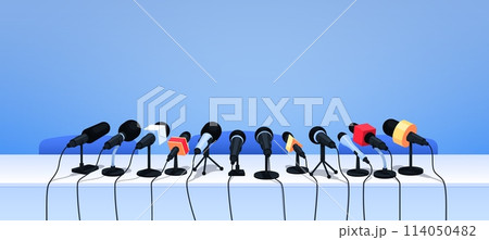 Press conference microphones on table. Cartoon vector background with professional equipment for interview, speech, mass media event, news, report, presentation, broadcasting, journalism or politics Press conference microphones on table. Cartoon vector background with professional equipment for interview, speech, mass media event, news, report, presentation, broadcasting, journalism or politics 114050482