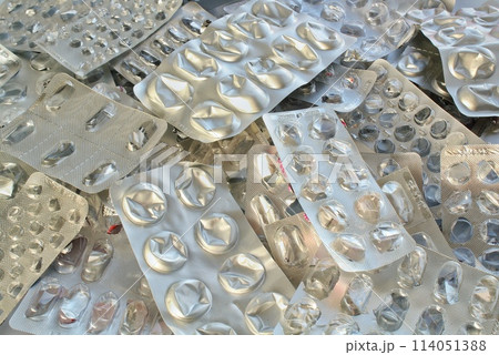 Pile of empty pill blister packs. Treatment and medication concept. Empty blister packages for recycling. Separate garbage sorting. Close up of clinical waste. Reducing medical waste disposal Pile of empty pill blister packs. Treatment and medication concept. Empty blister packages for recycling. Separate garbage sorting. Close up of clinical waste. Reducing medical waste disposal 114051388