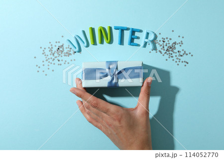 The word "winter" is made of colored plasticine on a blue background. 114052770