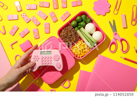 Pink lunch box with food and a pink gamepad Pink lunch box with food and a pink gamepad 114052850