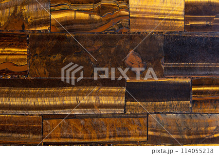 Tigers Eye Golden semi precious stone background, luxury texture material. Tigers Eye Golden semi precious stone background, luxury texture material. 114055218