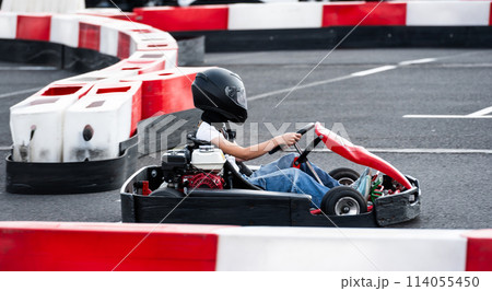 Small Girl Rides On A Kart On A Race Track, Enjoying Extreme Entertainment 114055450