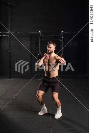 Man lifting a weight with hand, one arm dumbbell snatch, bare chest. Routine workout for physical and mental health. Man lifting a weight with hand, one arm dumbbell snatch, bare chest. Routine workout for physical and mental health. 114055645