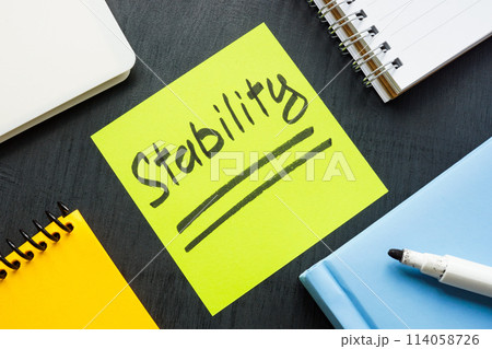 Word Stability on sticker among office items. Word Stability on sticker among office items. 114058726
