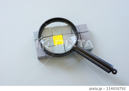 Gray cubes and one yellow one with a magnifying glass. Talent search and recruiting. Gray cubes and one yellow one with a magnifying glass. Talent search and recruiting. 114058792