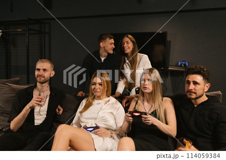 Couples revel in weekend home party with video games 114059384