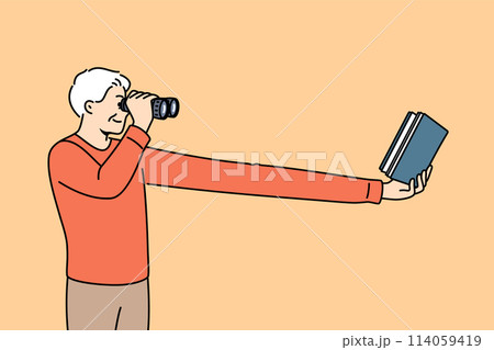 Myopic elderly man uses binoculars to read book, needs corrective surgery on eye pupils 114059419