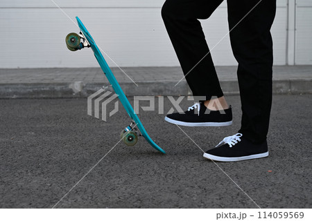 Beautiful and blonde girl practicing long board on the road 114059569
