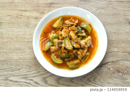 spicy boiled slice pork with eggplant in curry soup on plate 114059959