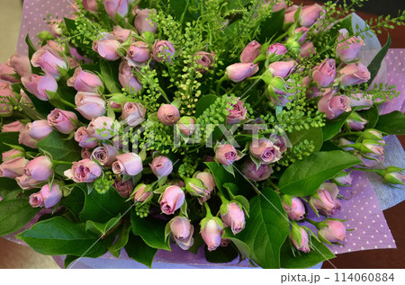 A large bouquet of small pink roses in close-up. 114060884