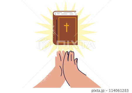 Bible with rays of light near hands of praying man who professes christian religion Bible with rays of light near hands of praying man who professes christian religion 114061283