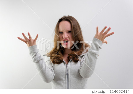 negative emotion of adolescence brain explosion girl with her hands shows how it explodes in her head experiences opens mouth waves hands boom strong explosion on a white background emotional teenager 114062414