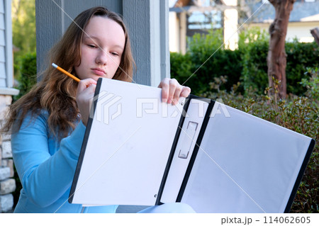 teenage girl draws with a pencil thinks dreams solves the problem do homework at home draw nature think over details design school education excellent student beautiful young lady woman teenage girl draws with a pencil thinks dreams solves the problem do homework at home draw nature think over details design school education excellent student beautiful young lady woman 114062605